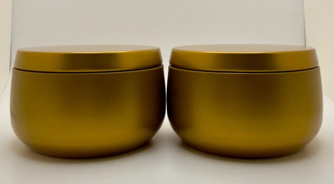 Two gold House of NIVREK candle vessels